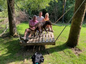 Family enjoying the wood swing